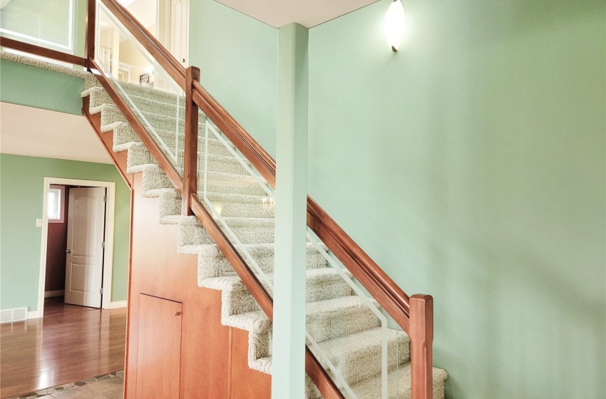 Staircase featuring glass railing