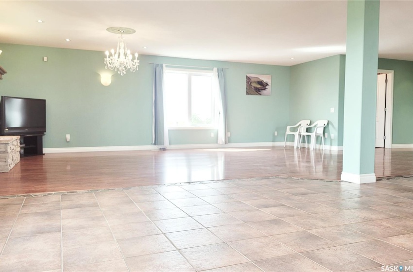 Dining area and living room with notable chandelier