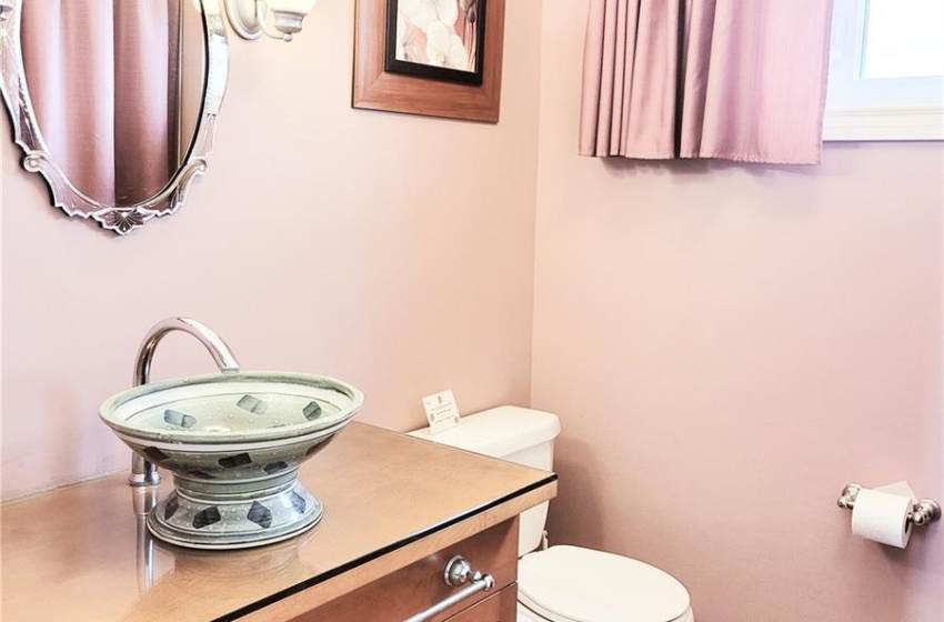 Bathroom with toilet, vanity, laminate flooring