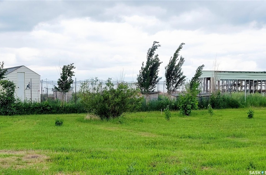 View of yard with small animal pen and a green house