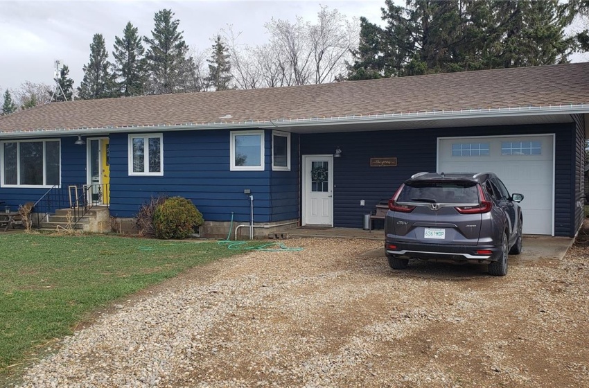 Ranch-style home with a front lawn and a garage