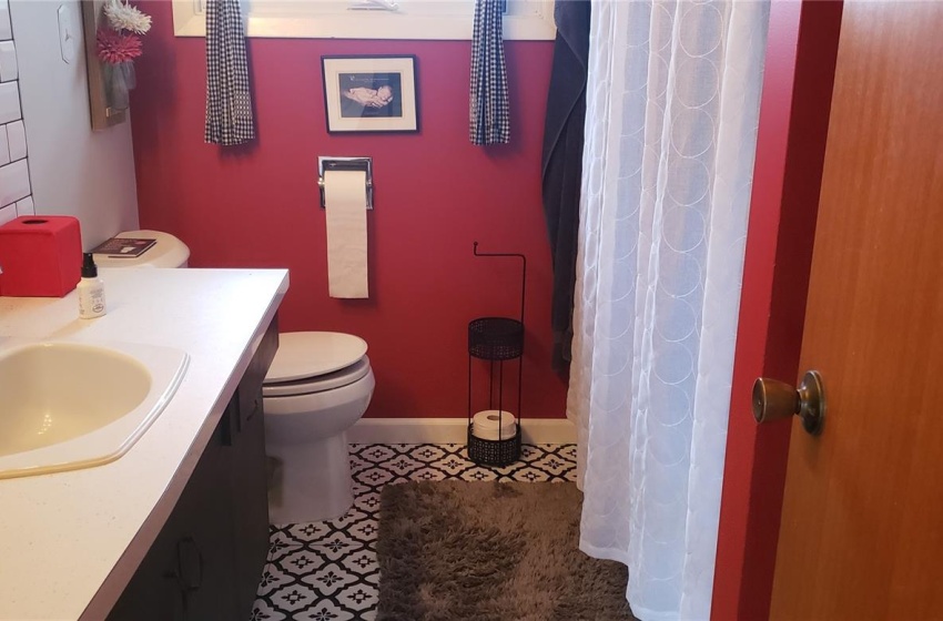 Bathroom featuring toilet, tile flooring, and vanity