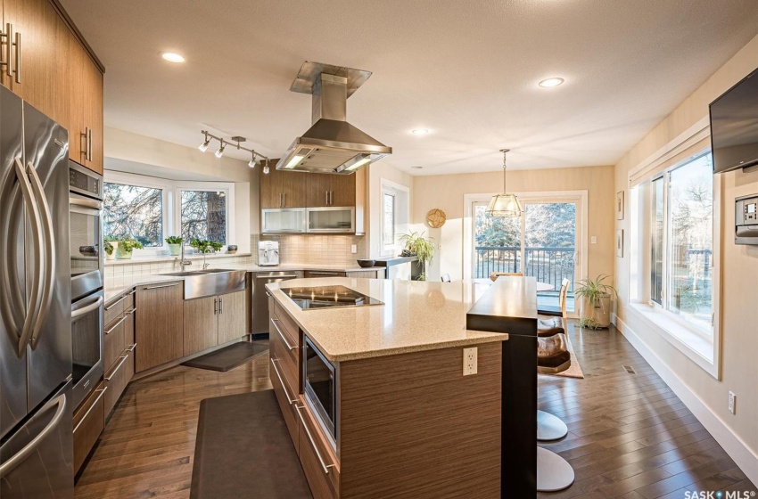 Kitchen featuring dark hardwood / wood-style flooring, island range hood, and plenty of natural light