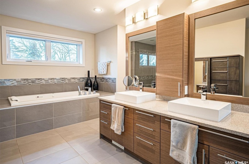 5 piece Bathroom with tile flooring, double sink vanity, and jetted tub