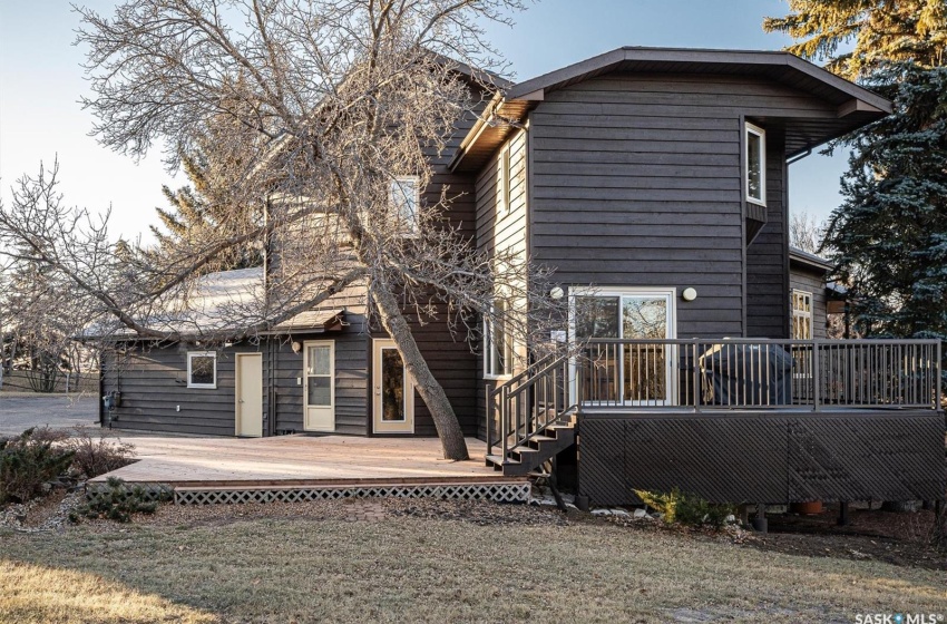 North side view of house with a wooden patio