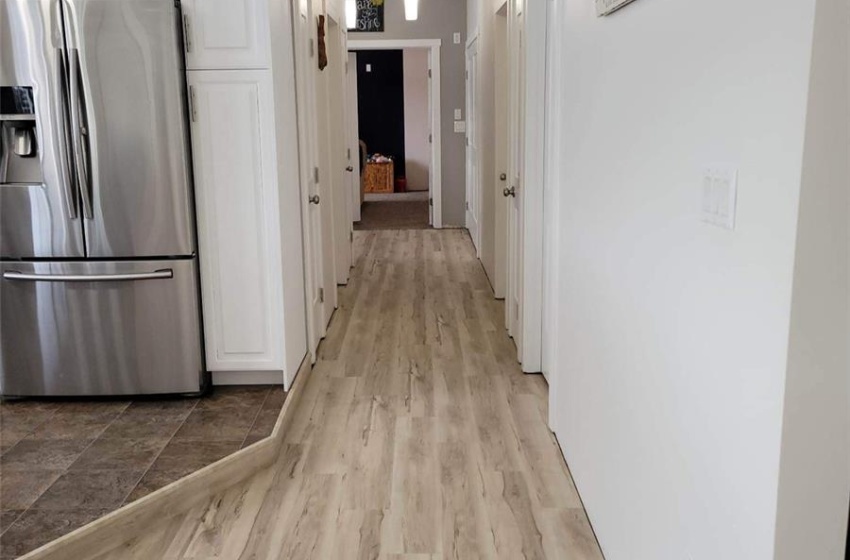 Hall with crown molding and light tile flooring