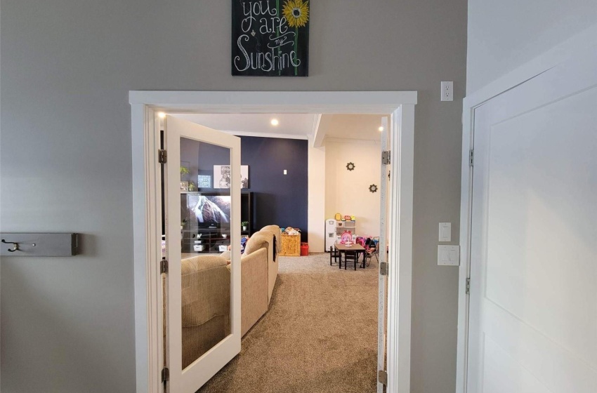 Hallway featuring dark colored carpet