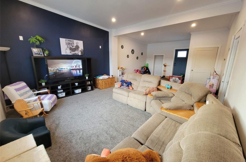 Carpeted living room featuring ornamental molding