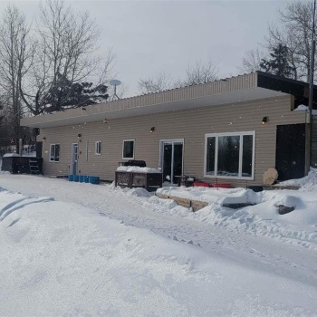 View of snow covered back of property