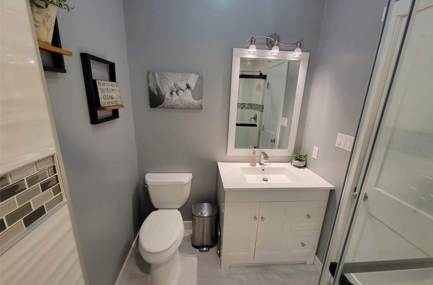 Bathroom featuring toilet, tasteful backsplash, tile floors, and vanity