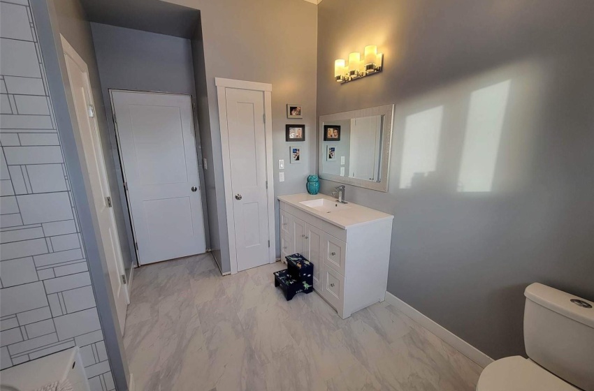 Bathroom featuring crown molding, toilet, vanity, and tile flooring