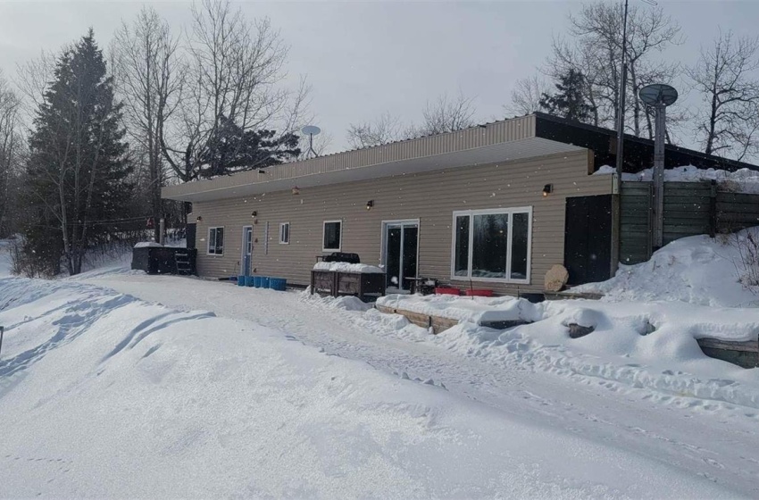 View of snow covered back of property