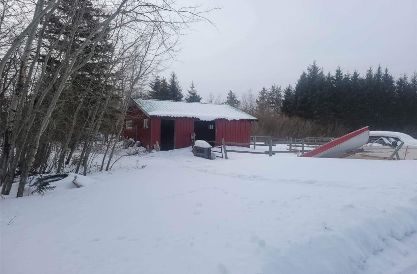 Yard covered in snow featuring an outdoor structure