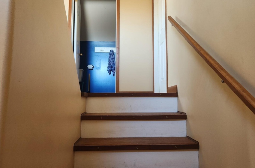 Staircase with hardwood / wood-style flooring