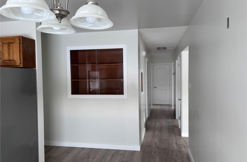 Hallway featuring view from kitchen to bedrooms