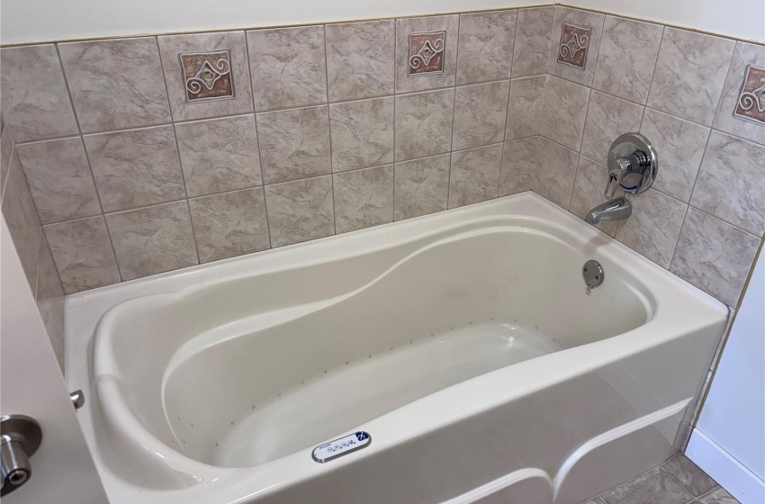 Bathroom with a tub and tile surround