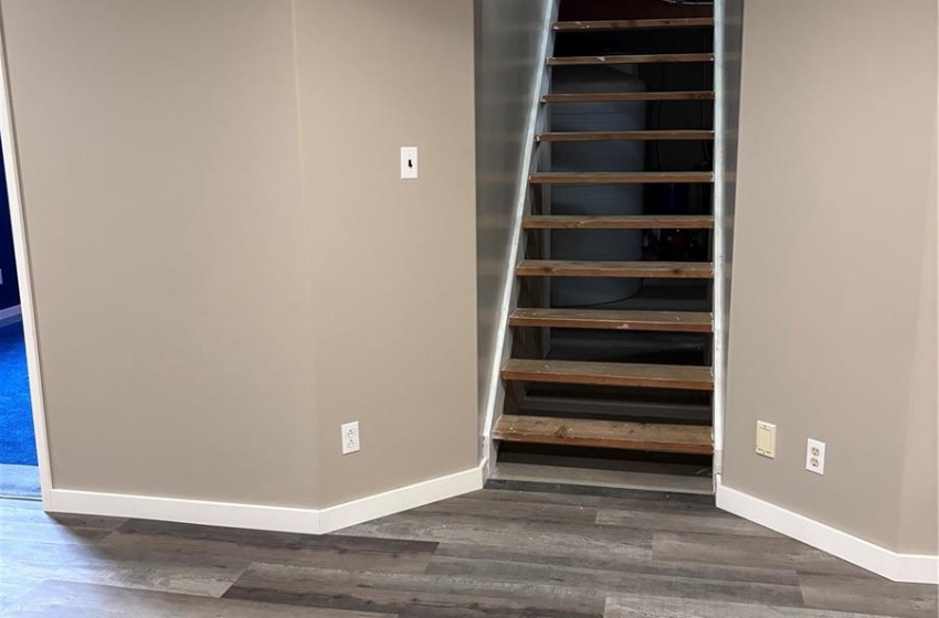 Basement featuring vinyl plank flooring and a paneled ceiling