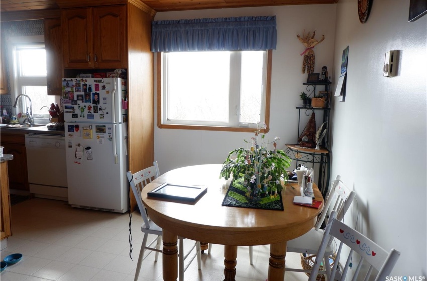 Dining space with sink and light tile floors