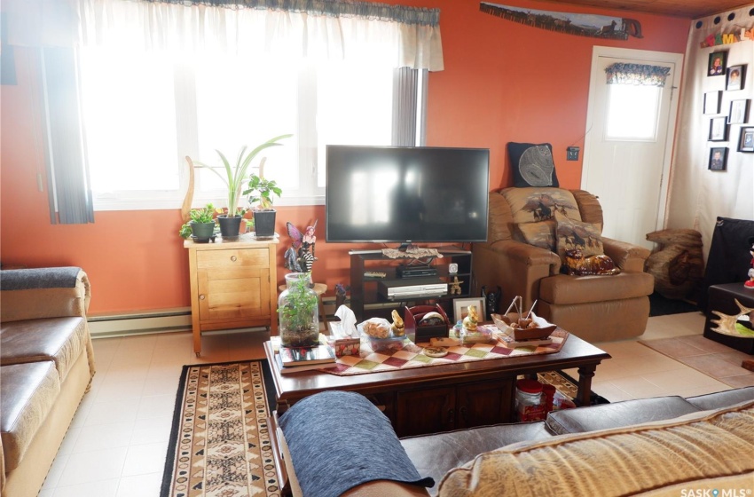 Tiled living room featuring a baseboard radiator