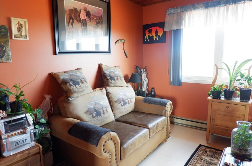 Bedroom with baseboard heating and light tile floors