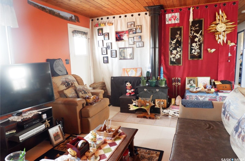 Living room featuring wood ceiling and tile flooring