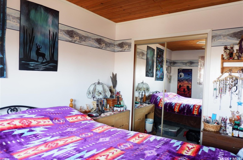 Bedroom with ornamental molding, a closet, and wood ceiling