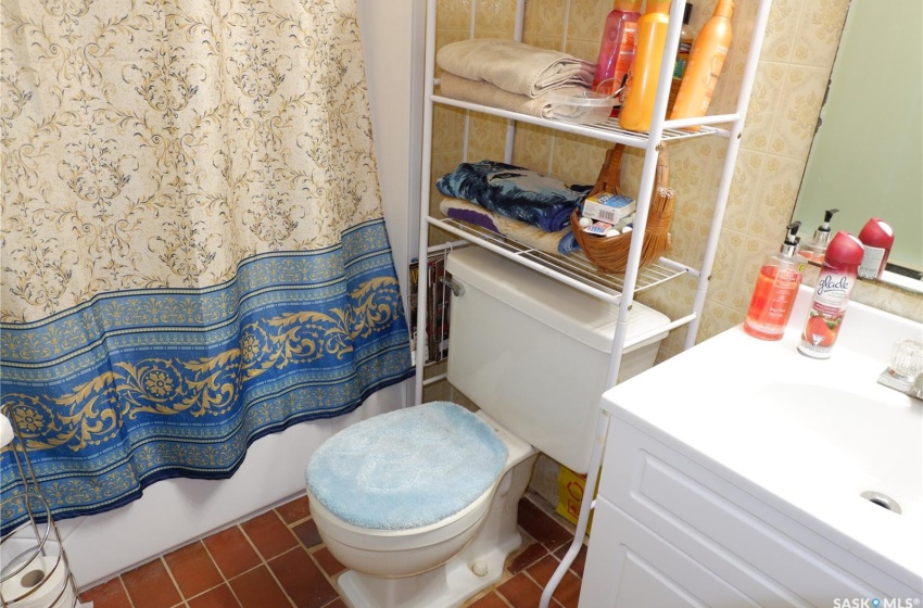 Bathroom featuring vanity, toilet, and tile floors