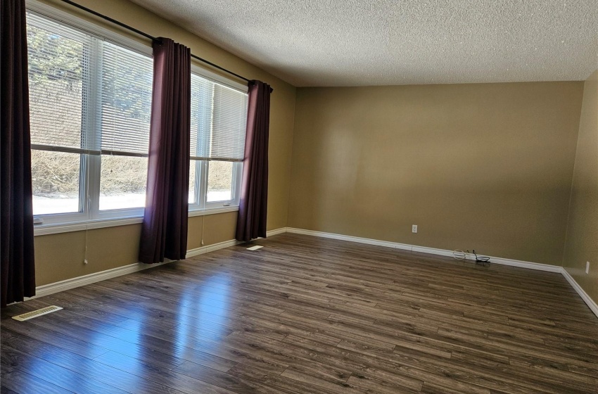 Family room with large window (facing West) - laminate floors