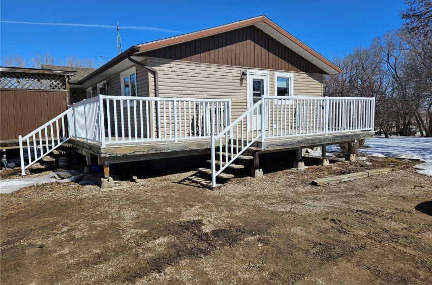 Rear view of house featuring a wooden deck