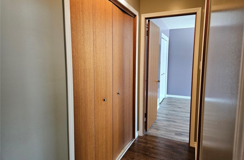 Hall with laminate floors - Lots of closet space - Going into Primary Bedroom