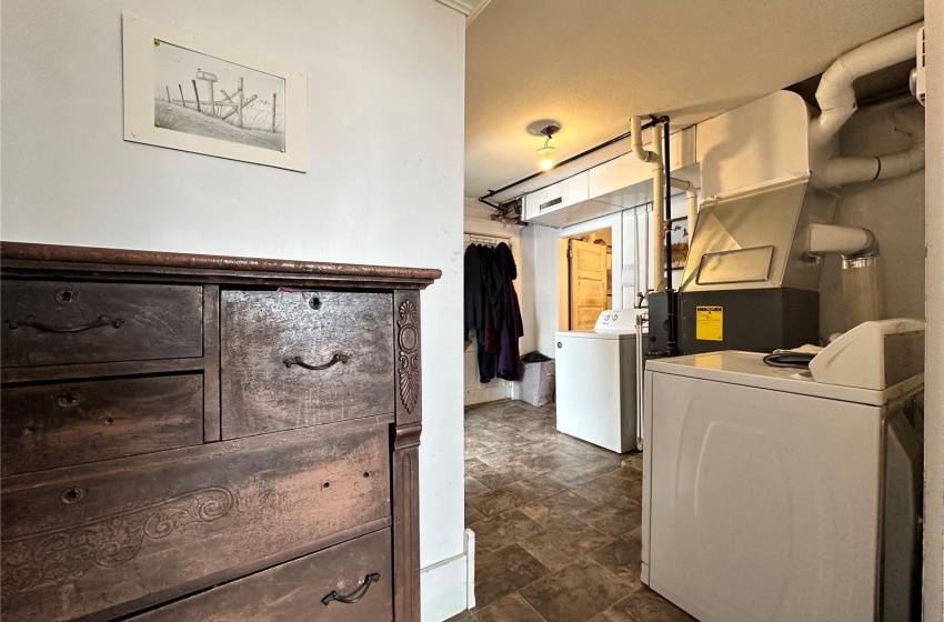 Laundry room featuring dark tile floors and independent washer and dryer