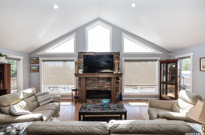 living room facing fireplace and huge windows