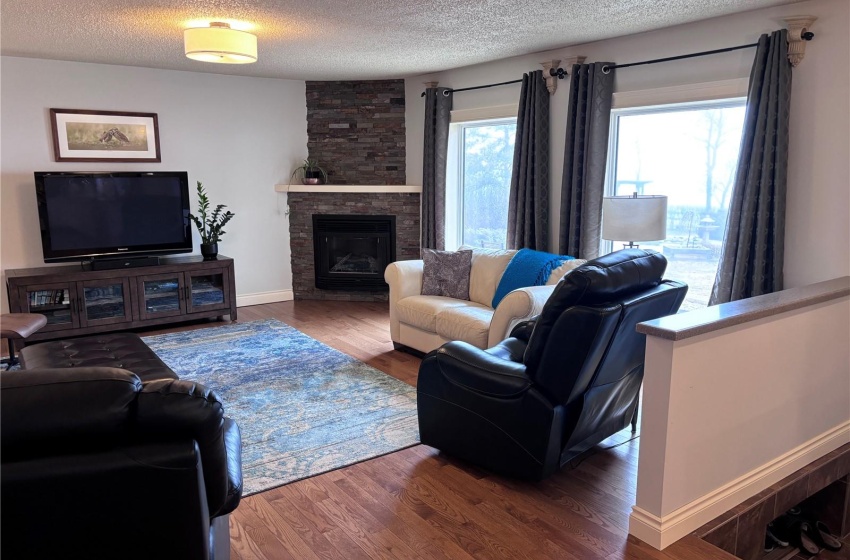 Living room with oak hardwood  floor, and a fireplace, south facing windows