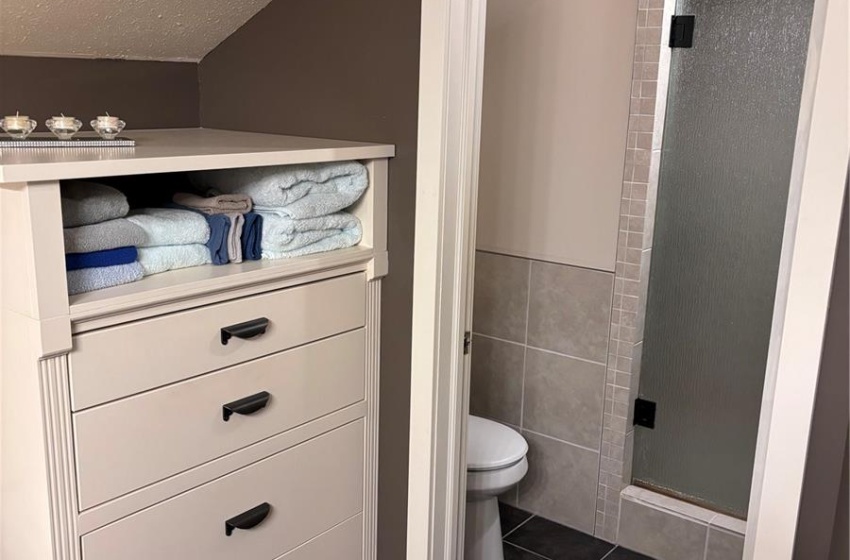 Primary bathroom with storage drawers and access to the shower/toilet area