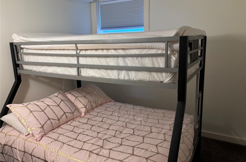 One of two identical bedrooms with carpet floors