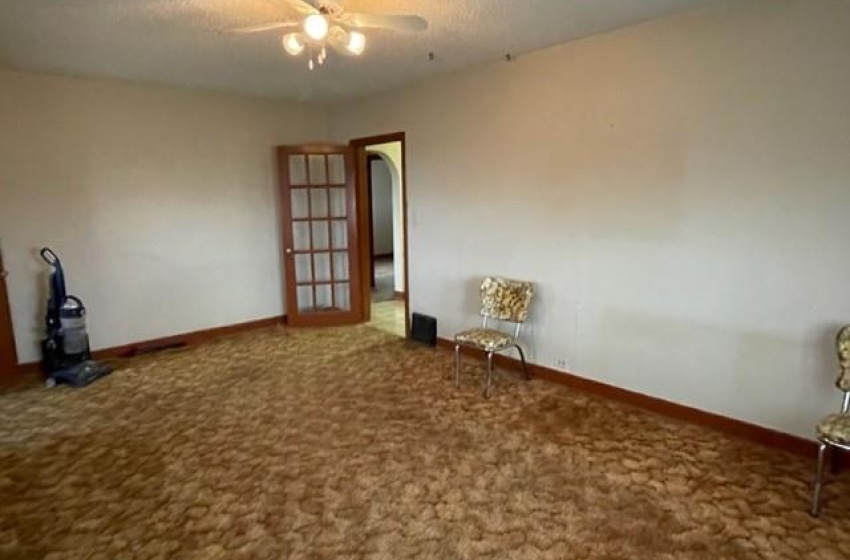 Carpeted living room and ceiling fan