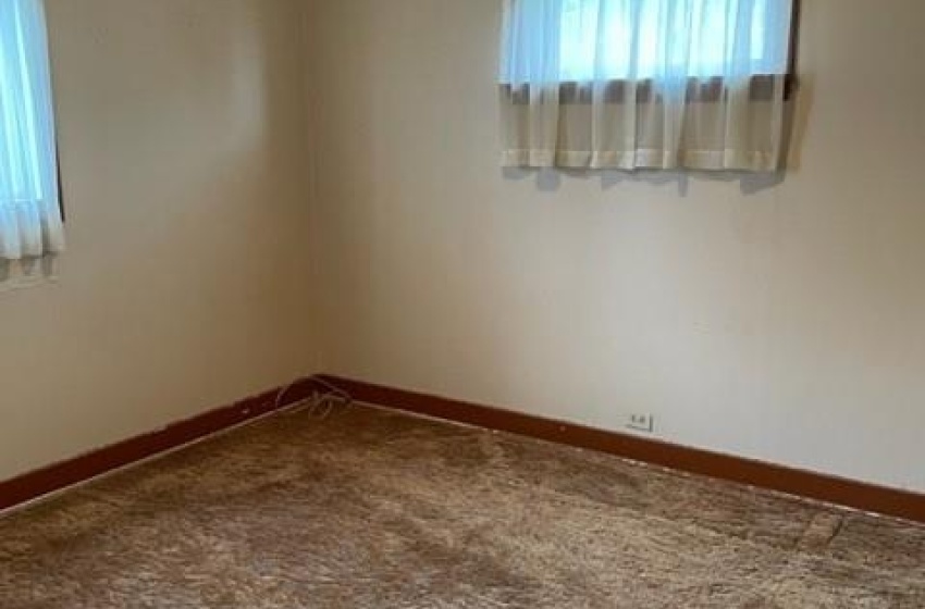 Carpeted spare room with a textured ceiling and a wealth of natural light