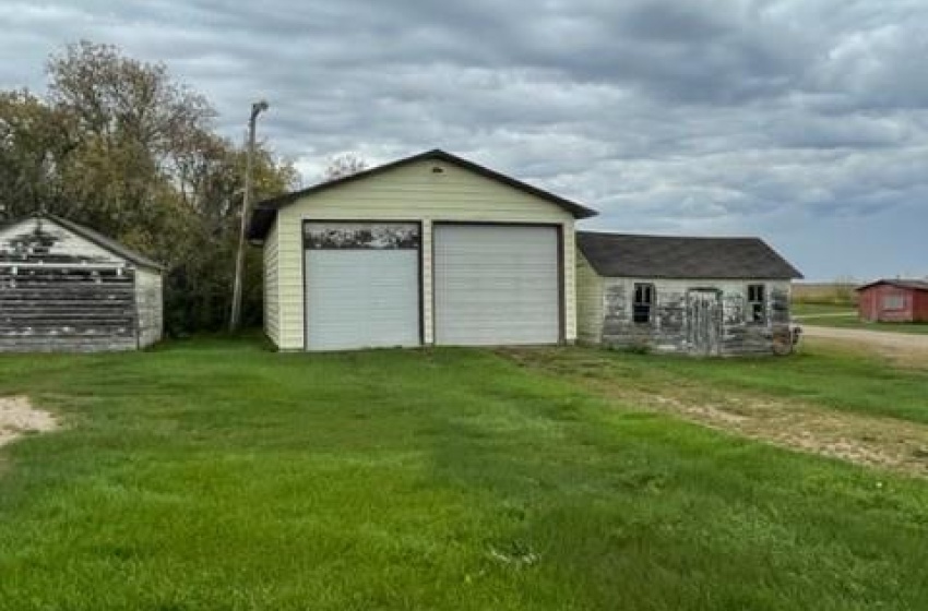 View of yard featuring a garage and an outdoor structure