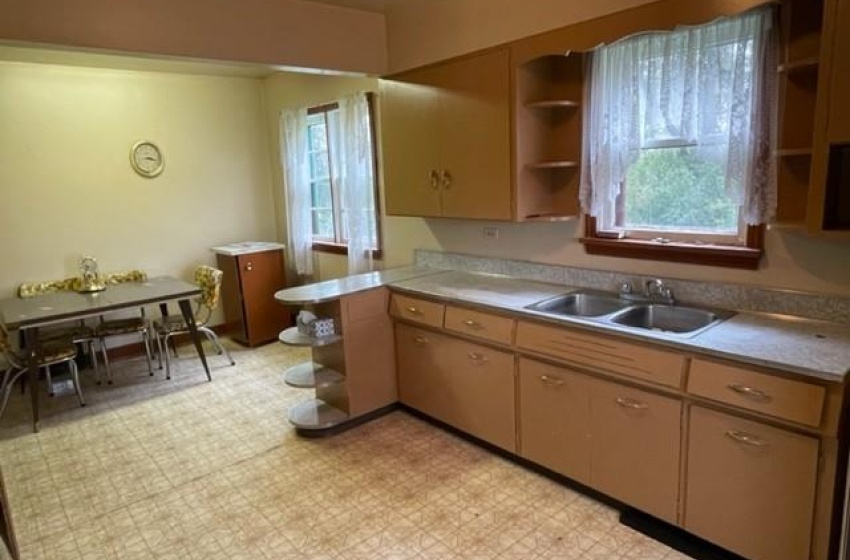 Kitchen featuring a healthy amount of sunlight, sink, and light tile floors