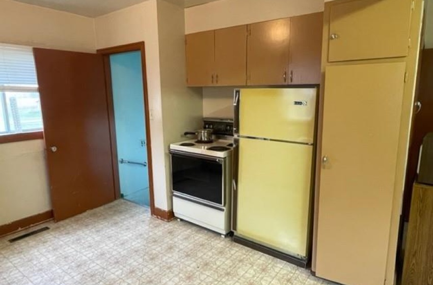 Kitchen featuring light tile flooring and white appliances