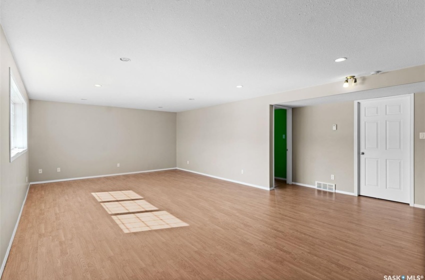 Spare room featuring light hardwood / wood-style floors and a textured ceiling