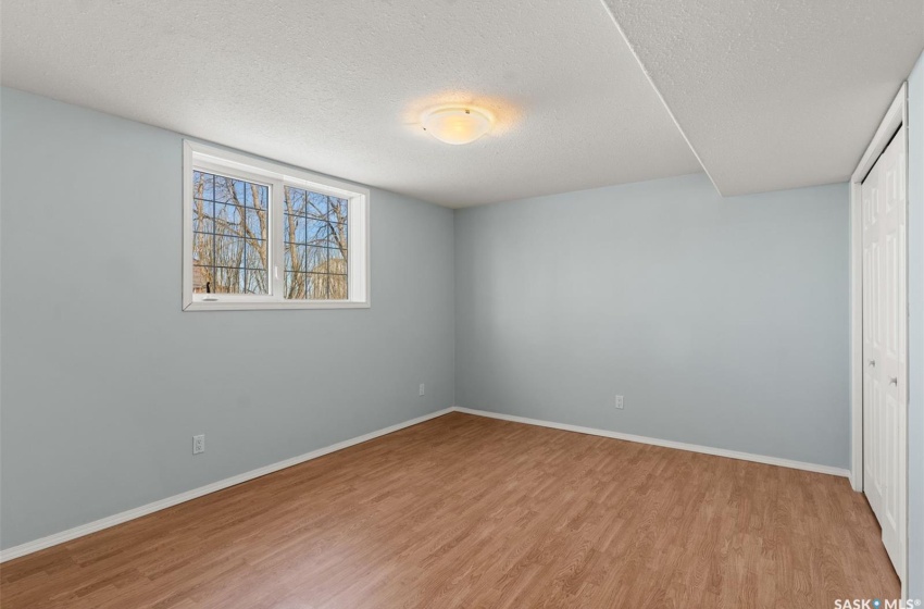 Unfurnished room featuring light hardwood / wood-style flooring and a textured ceiling