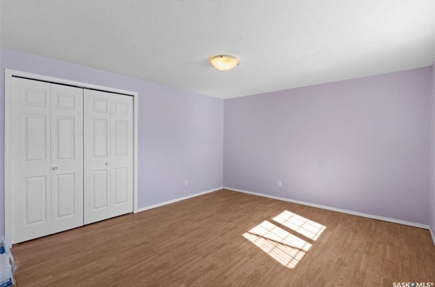 Unfurnished bedroom featuring a closet and wood-type flooring