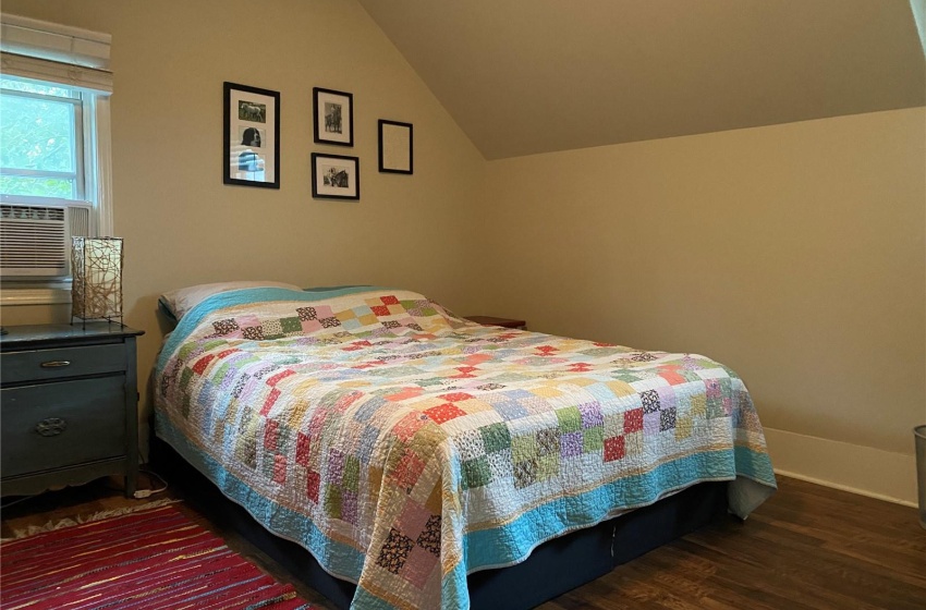 Primary Bedroom featuring dark hardwood / wood-style floors and vaulted ceiling