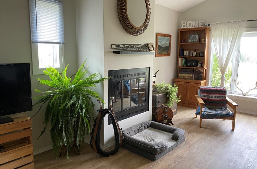 Living area featuring light hardwood / wood-style flooring and vaulted ceiling, Wood burning fireplace