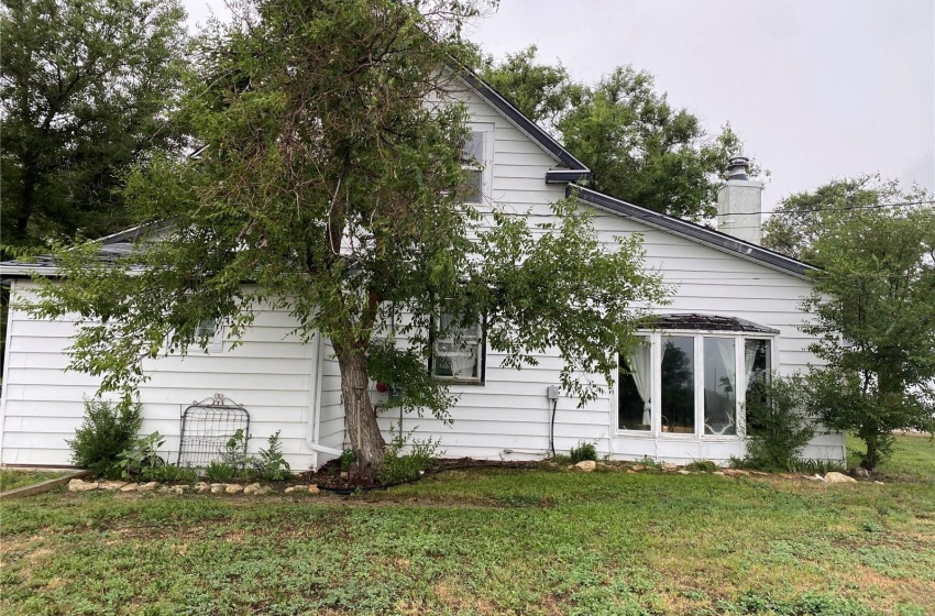 Side view of property with a lawn