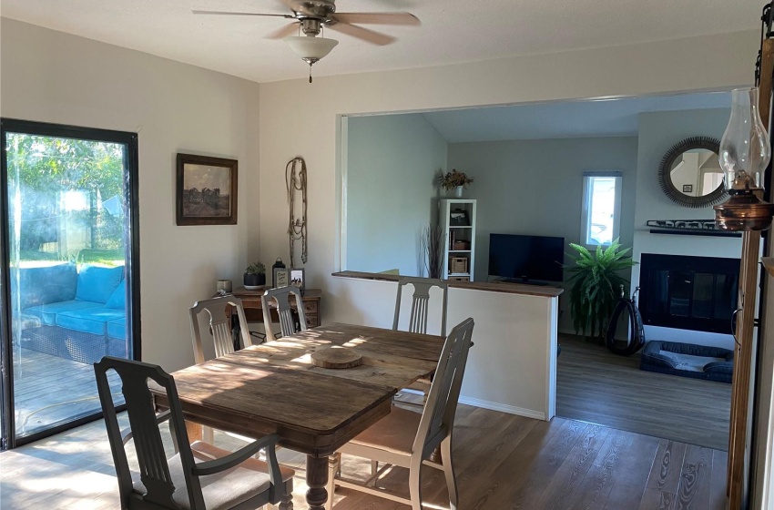 Dining area with dark hardwood / wood-style flooring and ceiling fan