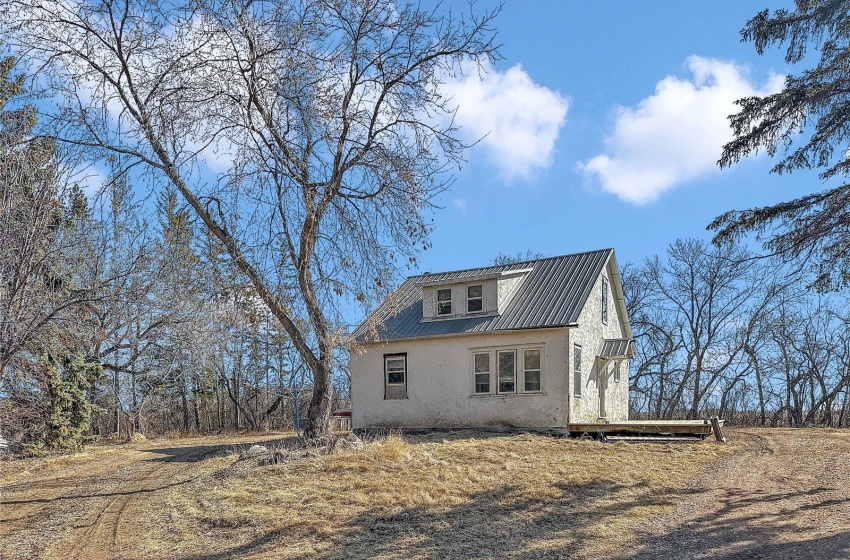 House with bush and slough seperating