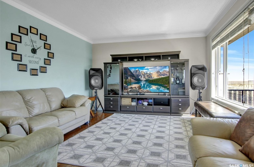 Living room featuring hardwood / wood-style floors and ornamental molding