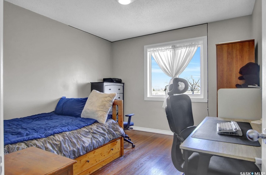 Bedroom featuring dark hardwood / wood-style floors and a textured ceiling